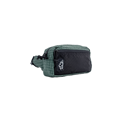 Green and black ULA Robic Spare Tire waist bag with compartments and a black zipper for hikers.