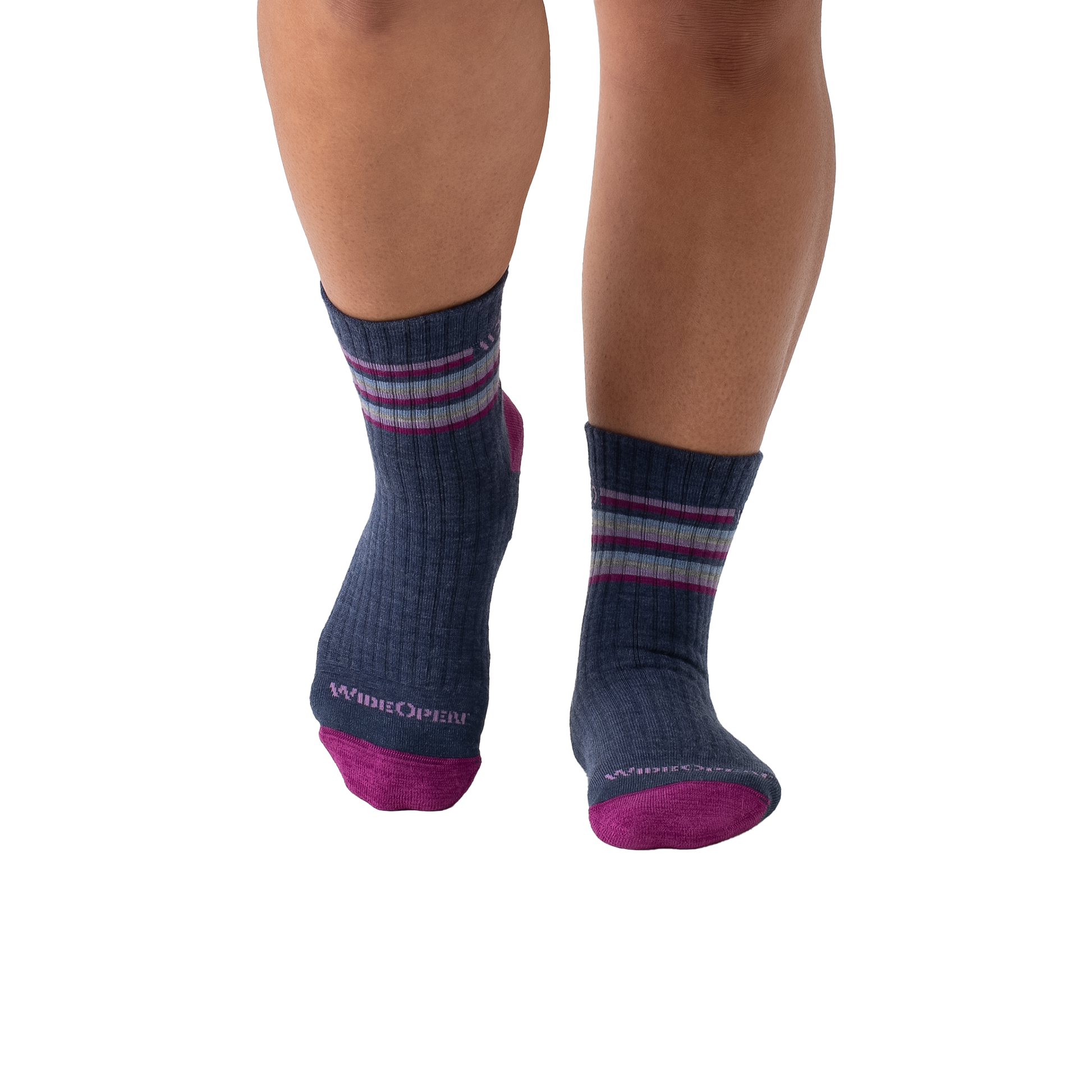 Close-up of a woman's legs in purple and blue striped socks, highlighting the soft Merino wool and midweight cushioning.