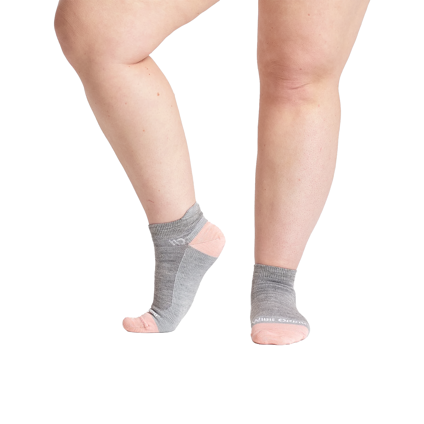 Woman's legs wearing grey ankle socks with pink trim, showcasing a minimalist design for casual shoes and sneakers.