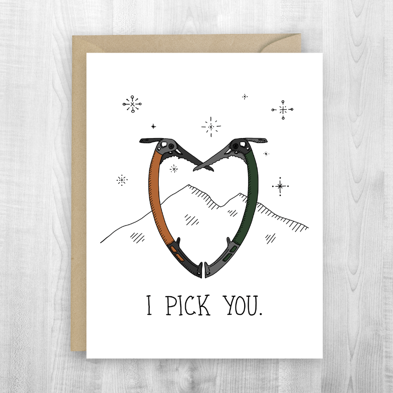A greeting card featuring two ice climbing tools forming a heart shape, with the text "I pick you" for winter adventure friendships.