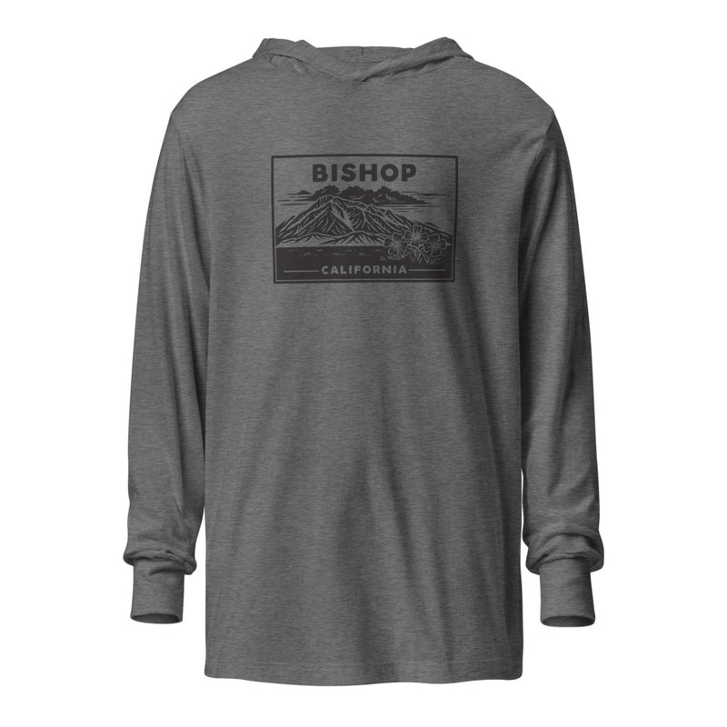 An image of the Mt. Tom Vintage Hooded Long Sleeve Tee featuring an illustration of Mount Tom on a grey triblend fabric. The tee has a hood and long sleeves, providing a cozy and trendy look.