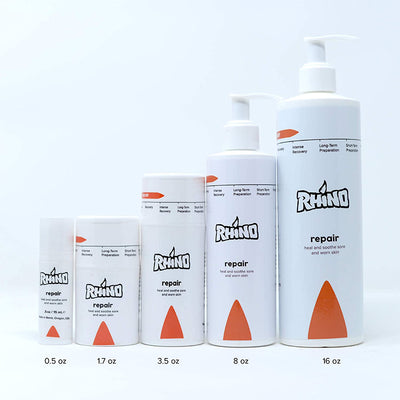 The image showcases three bottles of Rhino Repair products placed side by side. Each bottle comes in a different size and color, with white bottles and orange tops. This visually appealing arrangement suggests that these bottles are meant to be displayed together, possibly as a promotional set or for sale.