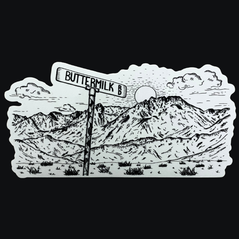 Black and white sticker with mountain scape and rd sign
